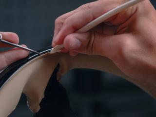 Focus of two hands during sewing work.