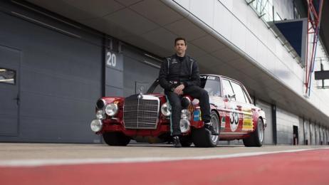 Picture of Toto Wolff sitting on the hood of the "Red pig"