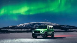 A Mercedes-AMG G-Class with northern lights in the background.