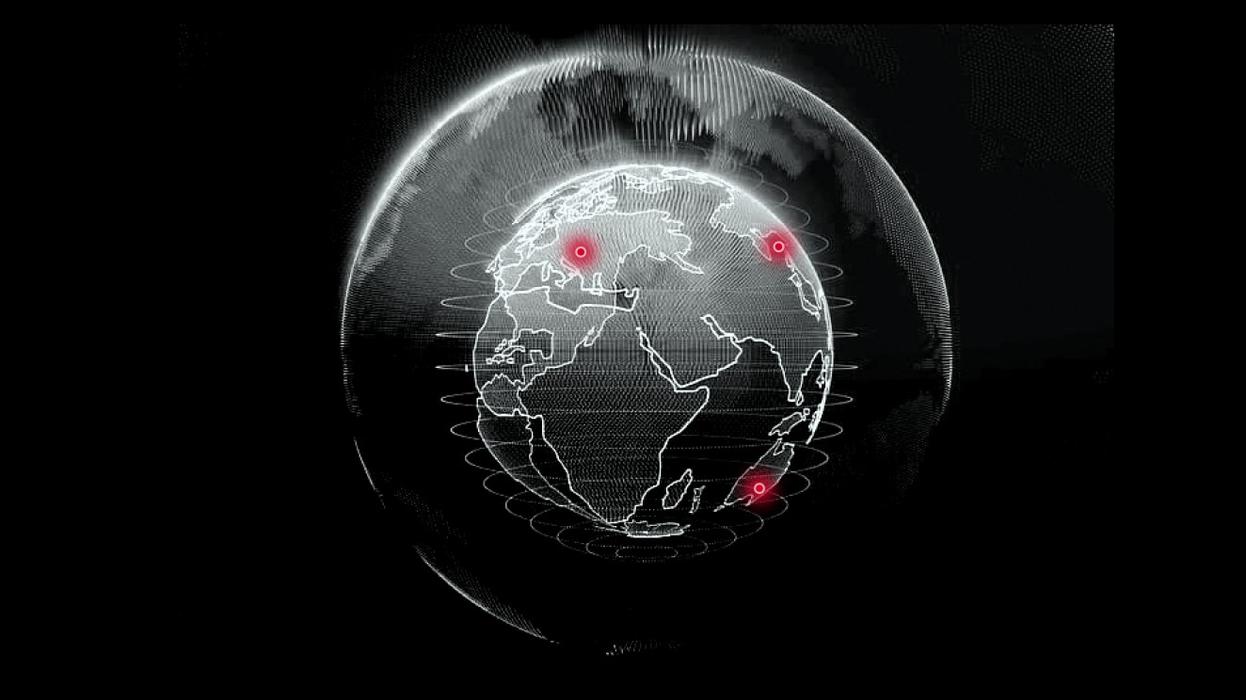 A black-and-white globe with red markings in Europe, Asia and Australia.